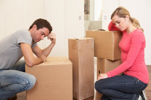 Professional movers carrying furniture in a Harrow property