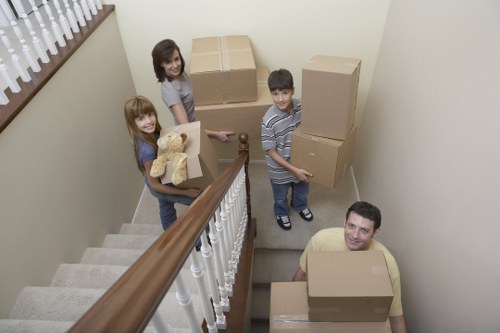 Piano movers navigating stairs and tight access in a Harrow residential property
